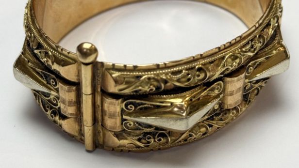 Bracelet manchette en or jaune (750) à décor filigrané et motifs géométriques.