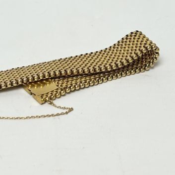 Bracelet articulé en or jaune 18 carats (750) à maillons tressés partiellement amatis et ciselés.